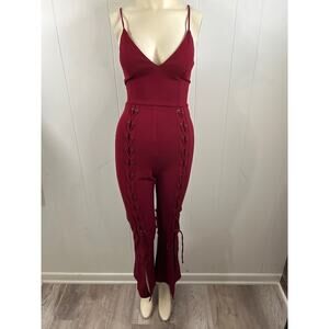 TRAC burgundy women’s size small lace up back jumpsuit. In excellent condition.